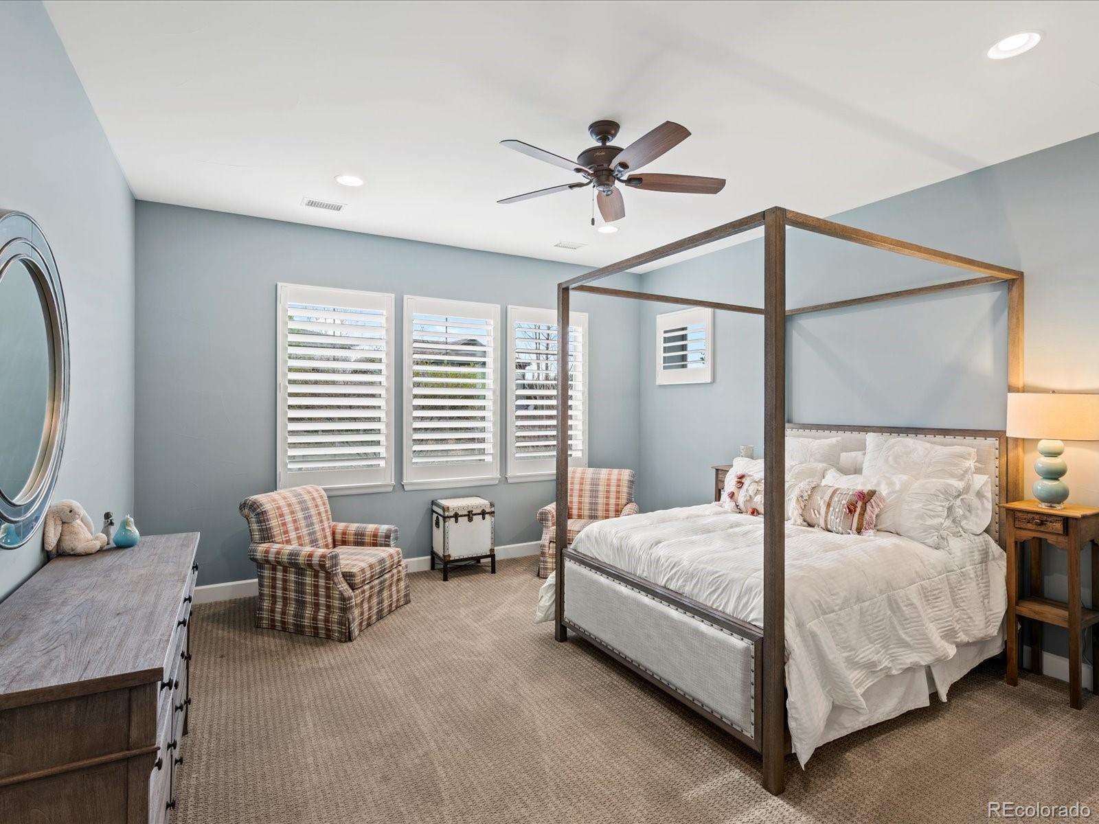 10553 Fairhurst Way Highlands Ranch, CO 80126 - Photo 28 of 35 a bedroom with a bed and a chandelier