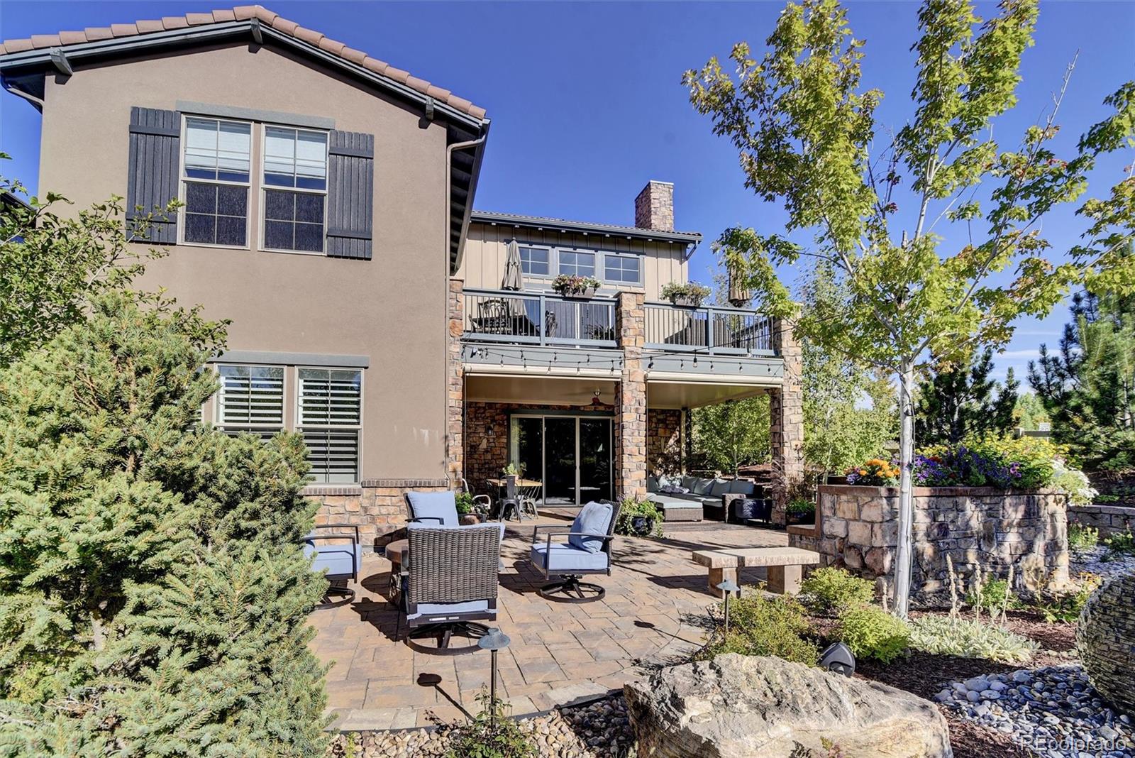 10553 Fairhurst Way Highlands Ranch, CO 80126 - Photo 3 of 35 a view of a patio with couches table and chairs and potted plants