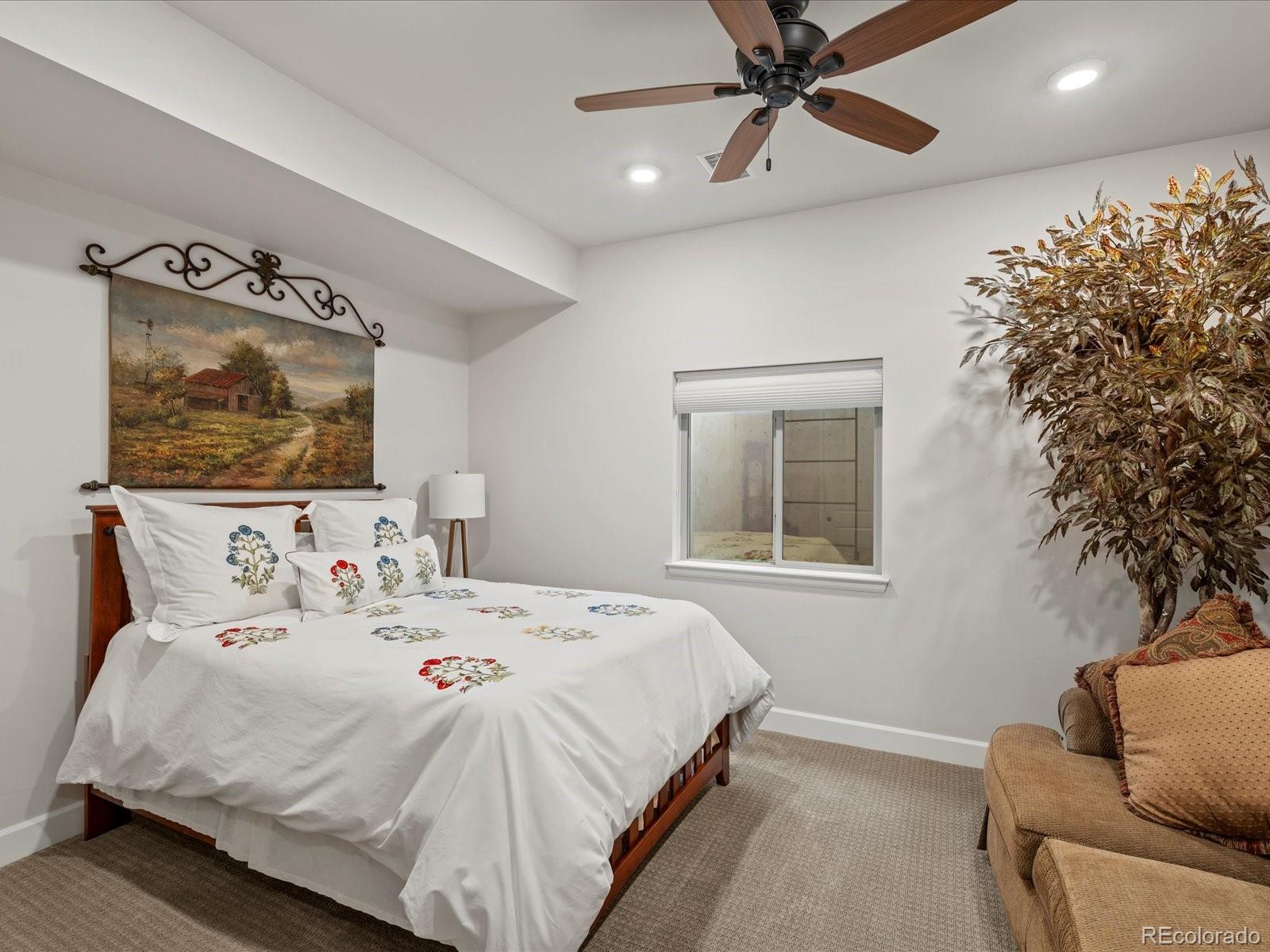 10553 Fairhurst Way Highlands Ranch, CO 80126 - Photo 31 of 35 a bedroom with a bed and a couch