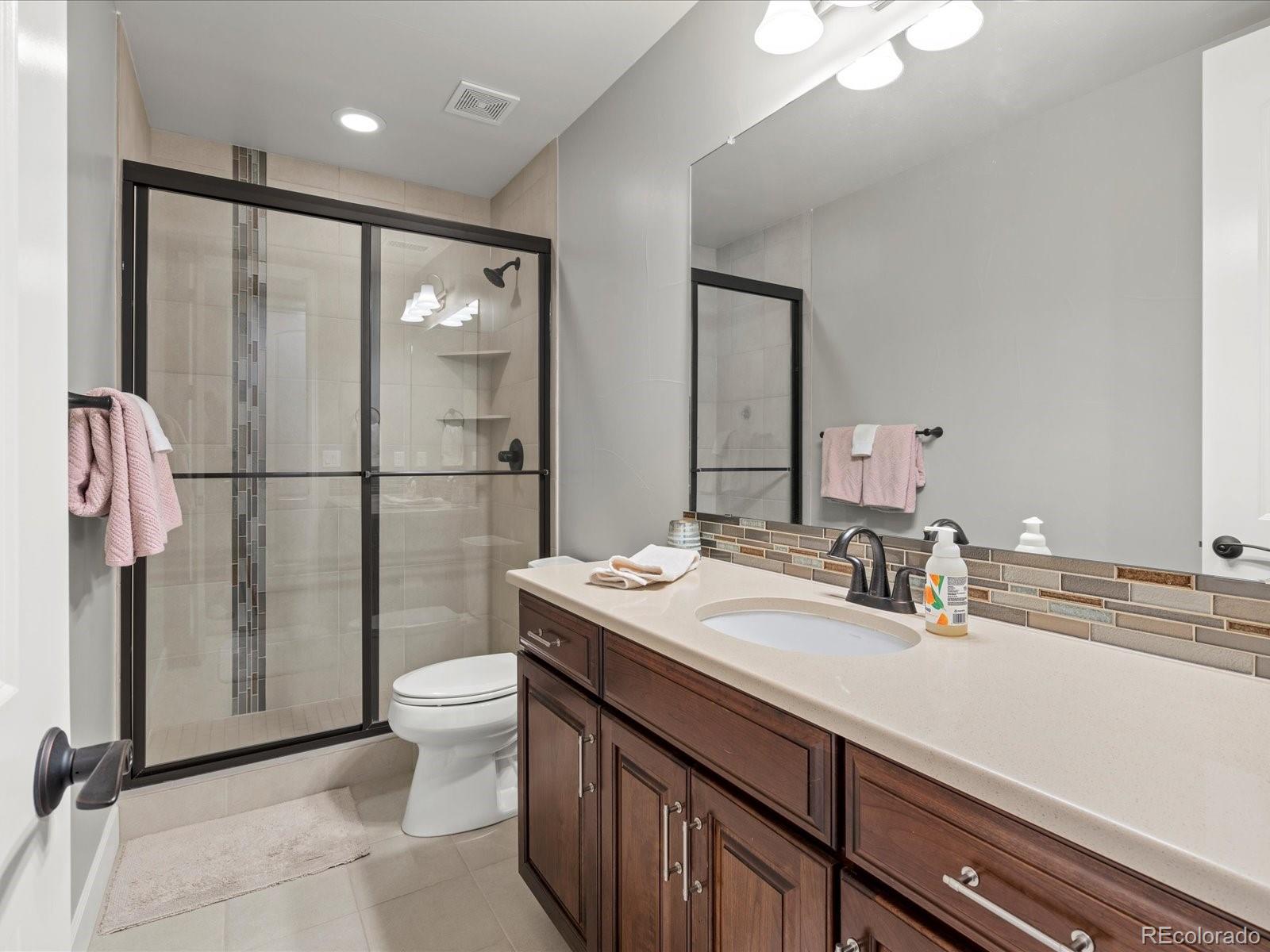 10553 Fairhurst Way Highlands Ranch, CO 80126 - Photo 32 of 35 a bathroom with a sink a toilet and shower