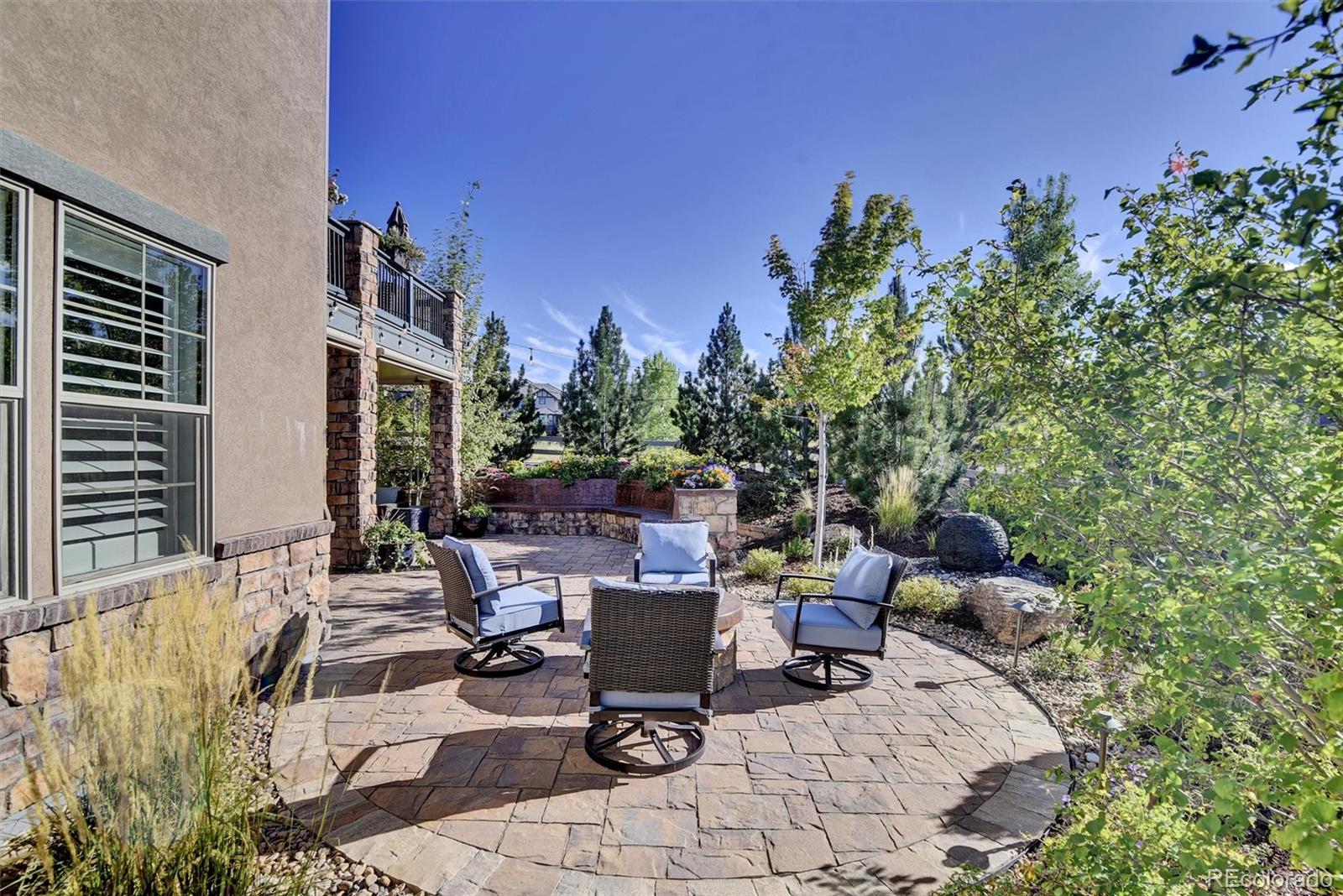 10553 Fairhurst Way Highlands Ranch, CO 80126 - Photo 4 of 35 a view of a patio with table and chairs and potted plants