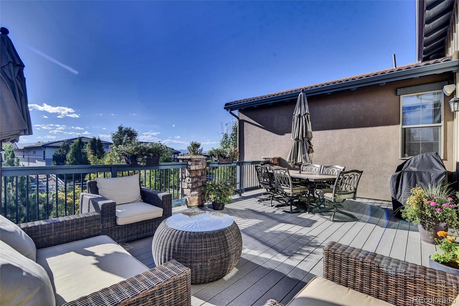 10553 Fairhurst Way Highlands Ranch, CO 80126 - Photo 7 of 35 a view of a patio with couches table and chairs and potted plants
