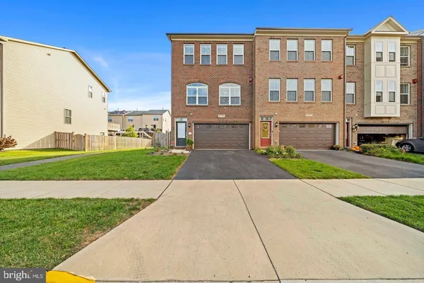a front view of a building with a garden