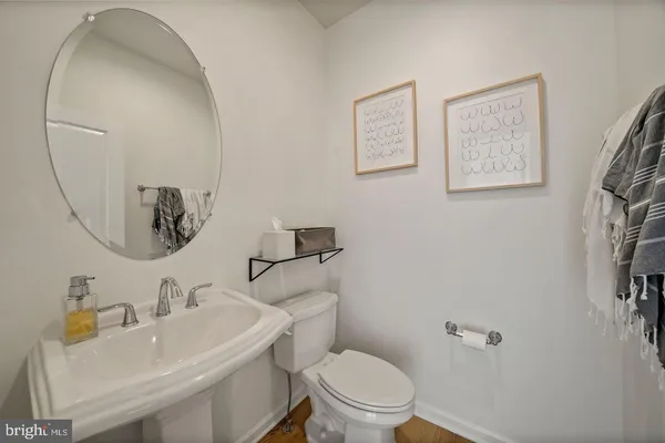 a bathroom with a sink mirror and toilet