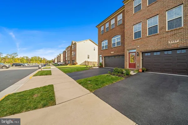 a view of a brick building next to a yard