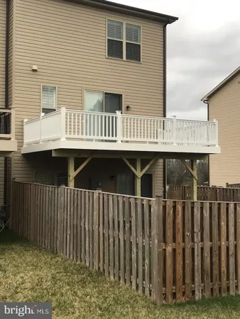a view of a house with wooden deck