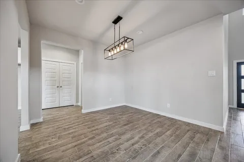 a view of a room with wooden floor