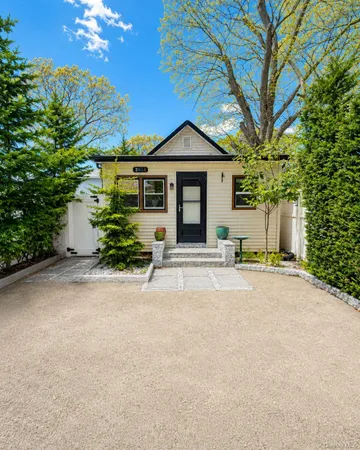 a front view of a house with a yard and a garage