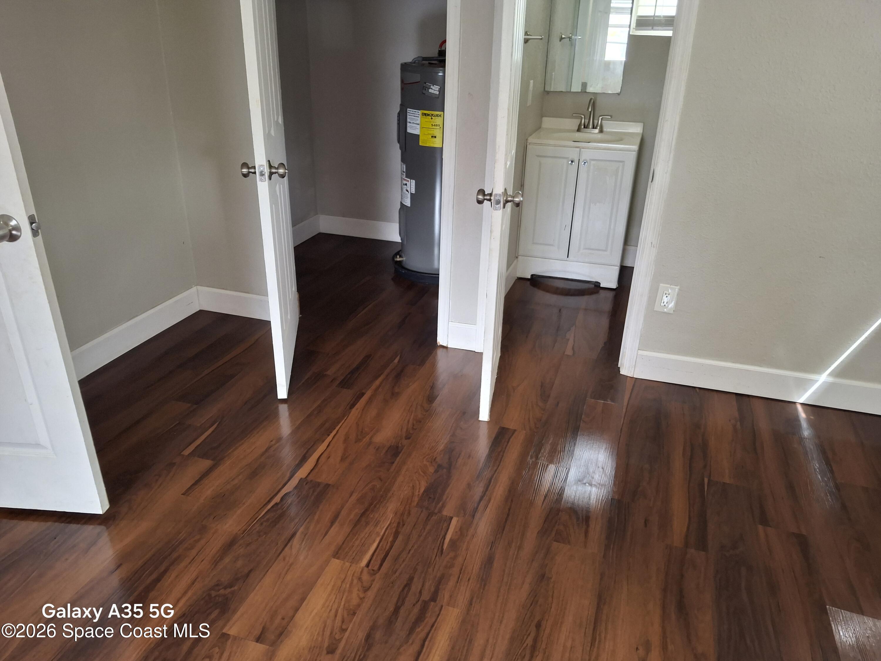 2263 Monroe Street Melbourne, FL 32905 - Photo 13 of 15 a view of a hallway with wooden floor and staircase