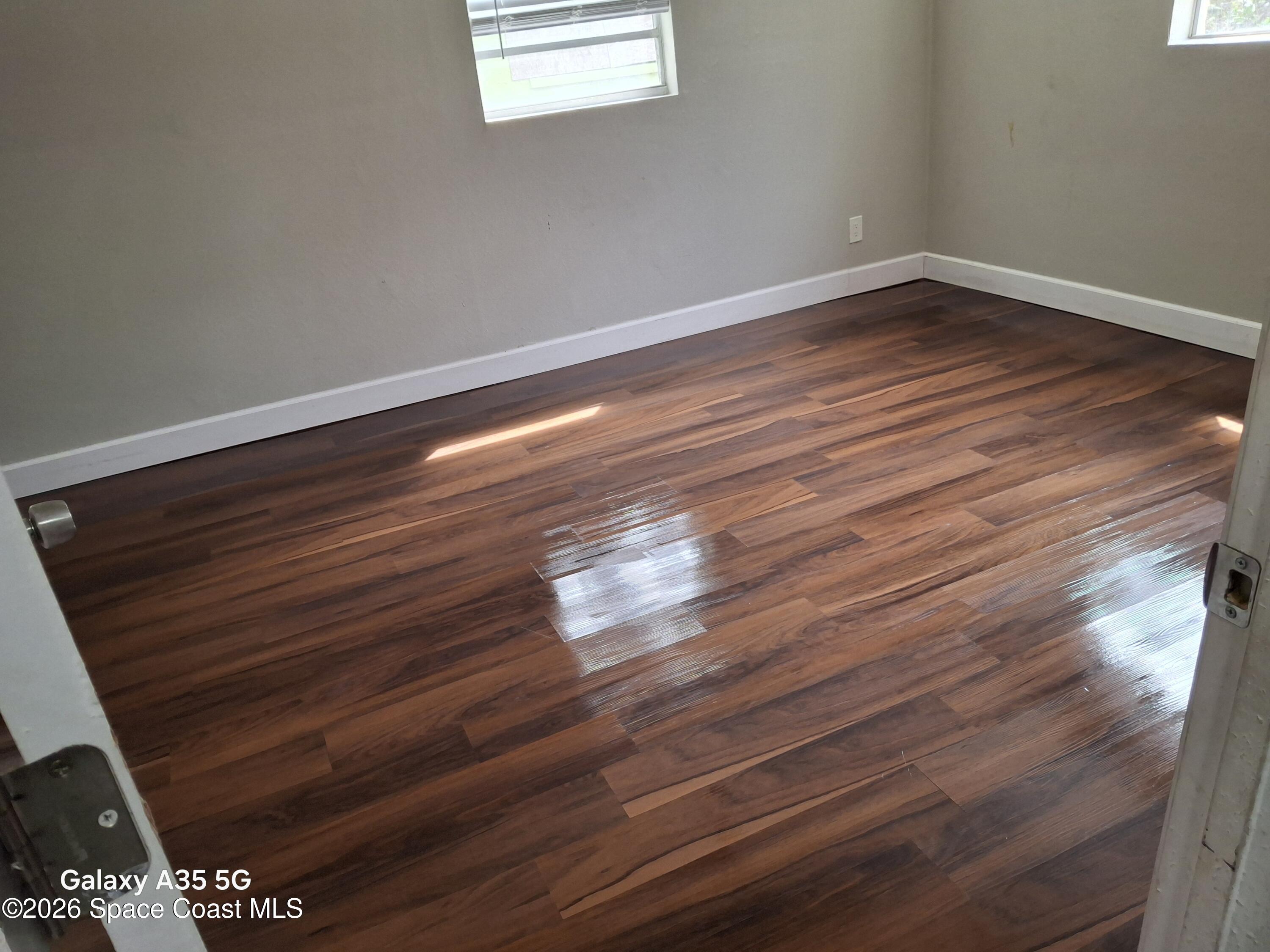 2263 Monroe Street Melbourne, FL 32905 - Photo 14 of 15 a view of room with wooden floor and fan