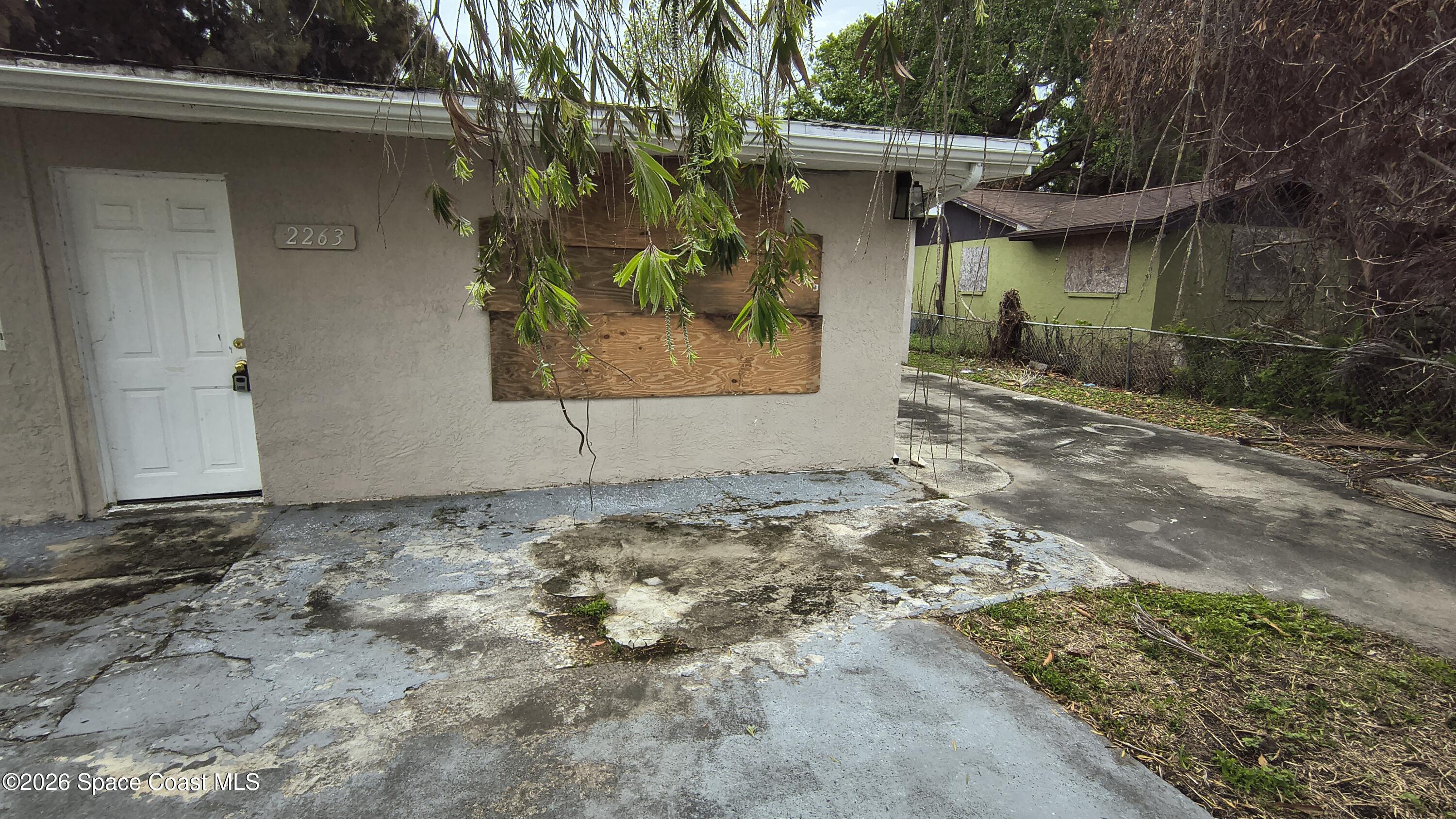 2263 Monroe Street Melbourne, FL 32905 - Photo 2 of 15 a front view of a house with garden