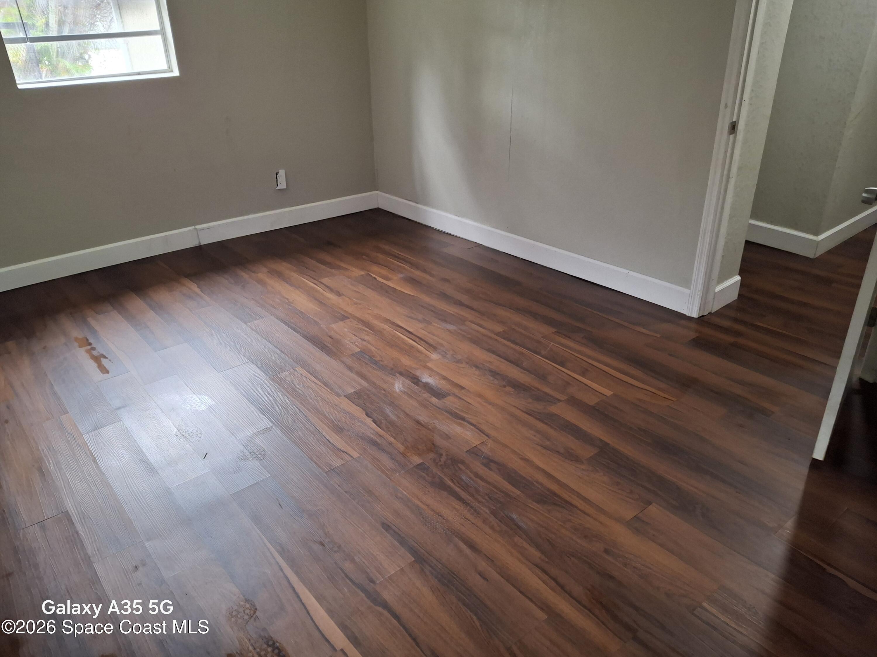 2263 Monroe Street Melbourne, FL 32905 - Photo 5 of 15 a view of a room with wooden floor and window