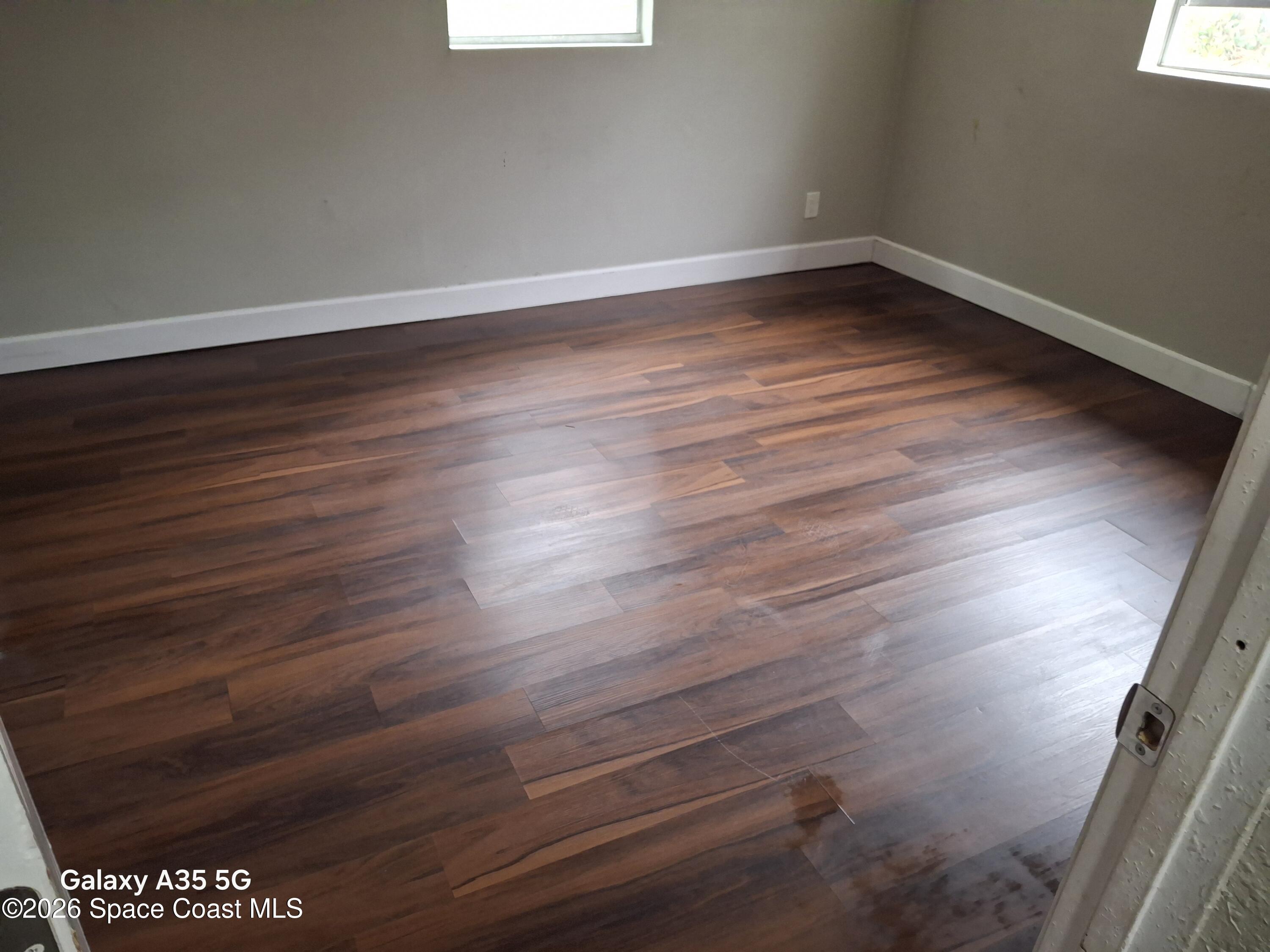 2263 Monroe Street Melbourne, FL 32905 - Photo 6 of 15 a view of an empty room with wooden floor