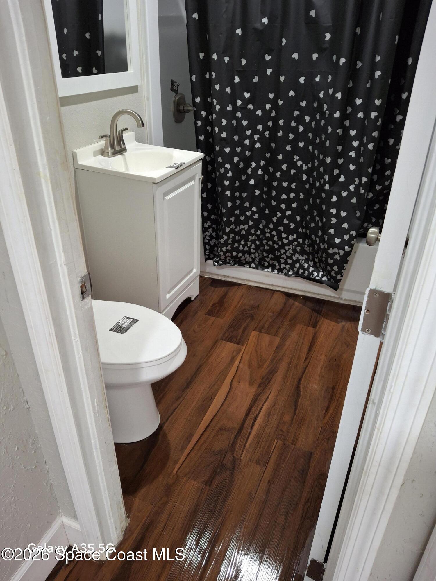 2263 Monroe Street Melbourne, FL 32905 - Photo 10 of 15 a bathroom with a sink and a toilet