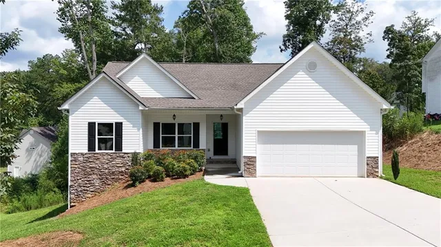 a view of a yard in front view of a house