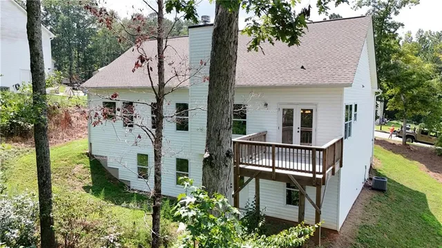 an aerial view of a house with swimming pool and sitting area