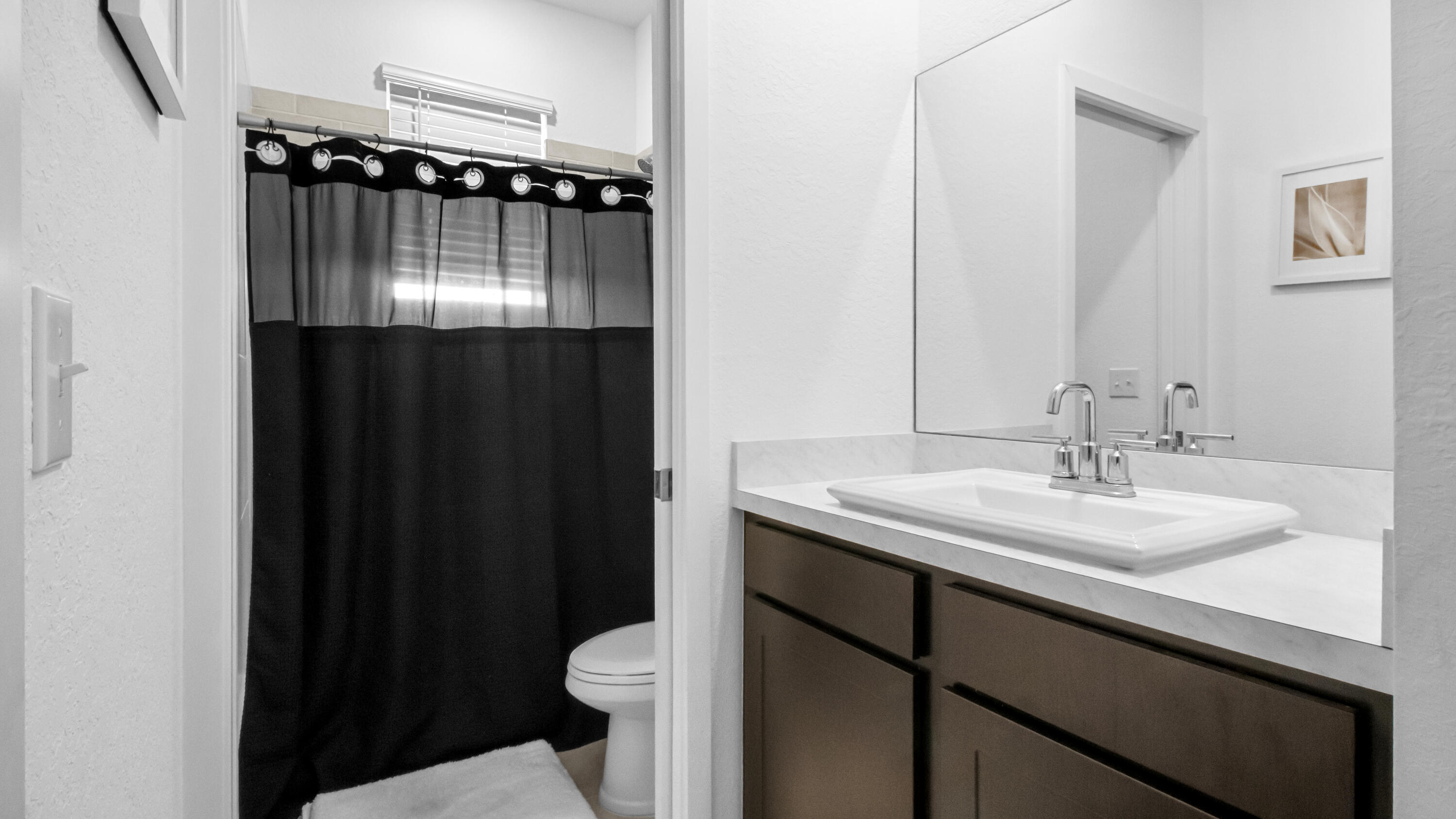 185 Bandol Street Riviera Beach, FL 33404 - Photo 15 of 28 a bathroom with a sink a toilet a mirror and shower