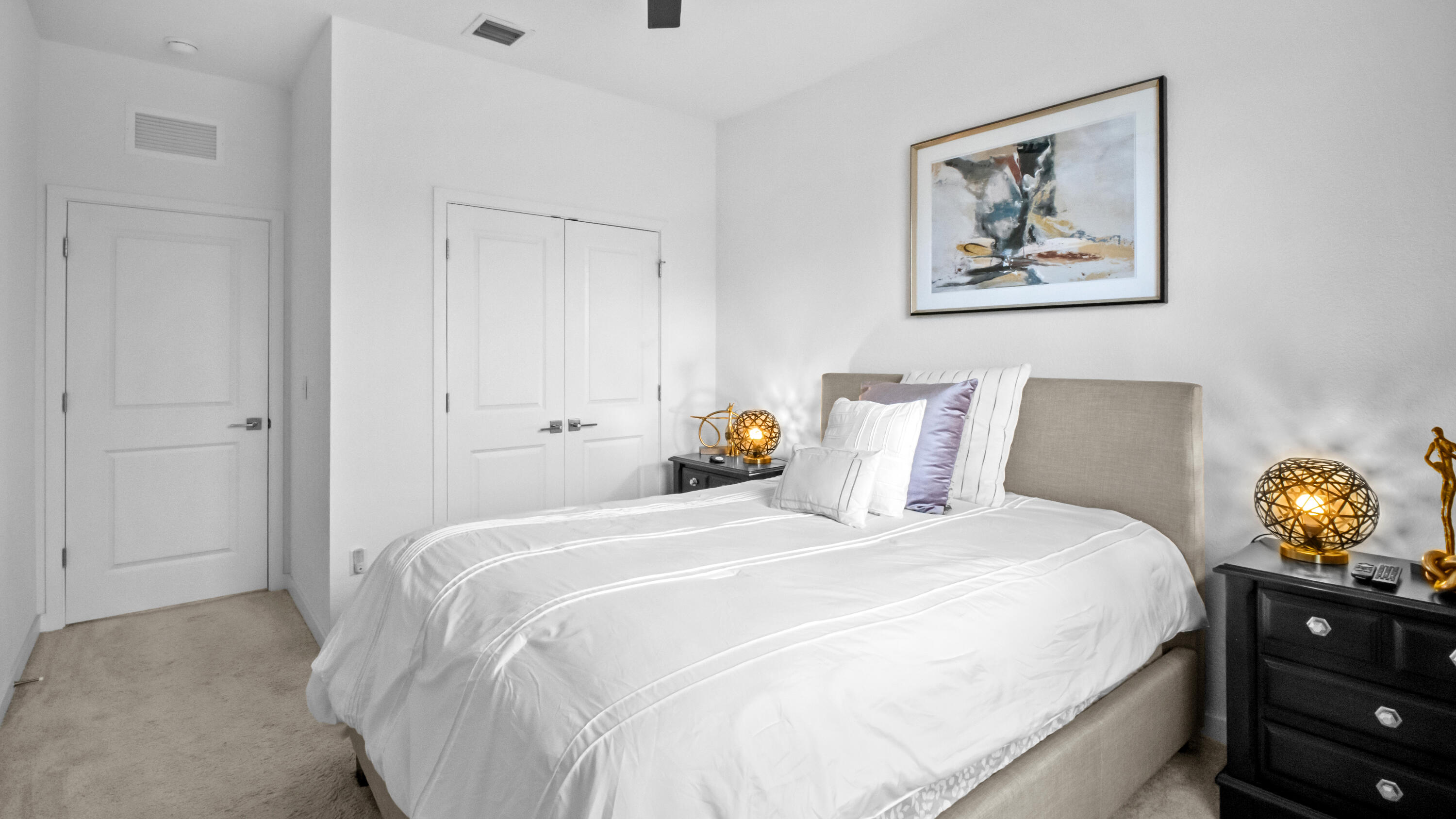 185 Bandol Street Riviera Beach, FL 33404 - Photo 26 of 28 a bedroom with a bed and a lamp on dresser