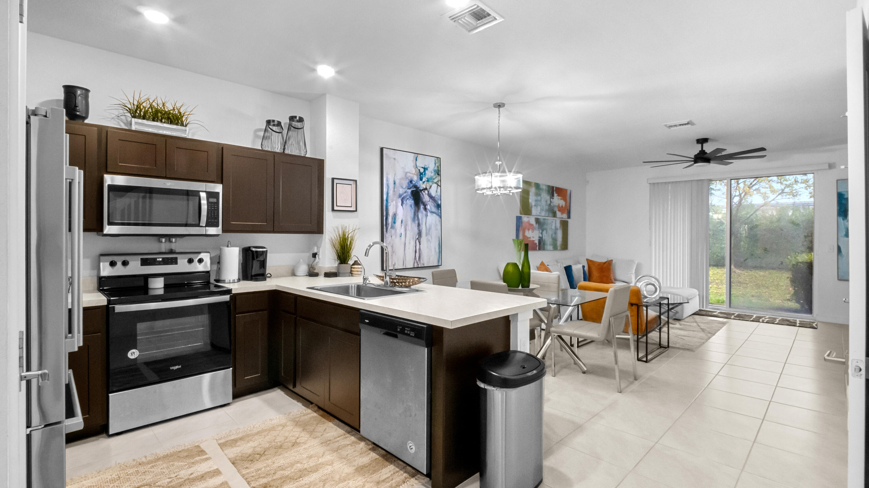 185 Bandol Street Riviera Beach, FL 33404 - Photo 3 of 28 a kitchen with a sink stainless steel appliances and cabinets