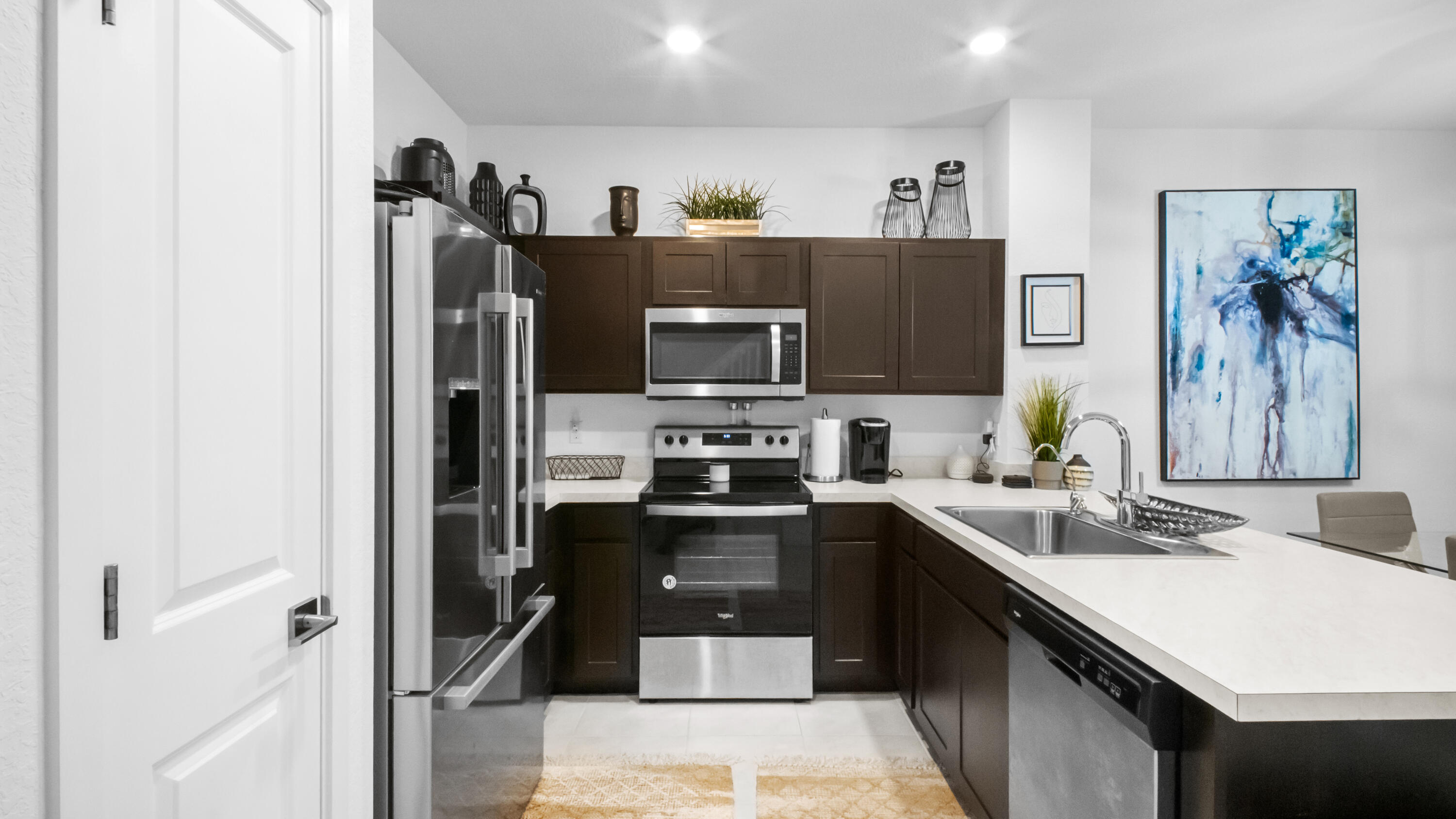 185 Bandol Street Riviera Beach, FL 33404 - Photo 4 of 28 a kitchen with stainless steel appliances a refrigerator stove and sink