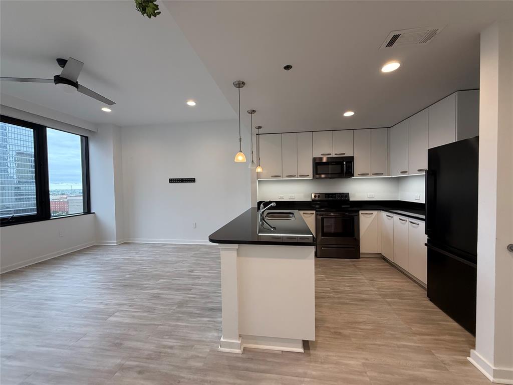 1200 Main Street, Unit 902 Dallas, TX 75202 - Photo 11 of 21 a kitchen with granite countertop a sink stove and refrigerator