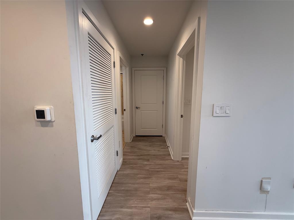 1200 Main Street, Unit 902 Dallas, TX 75202 - Photo 17 of 21 a view of a hallway with a wooden floor