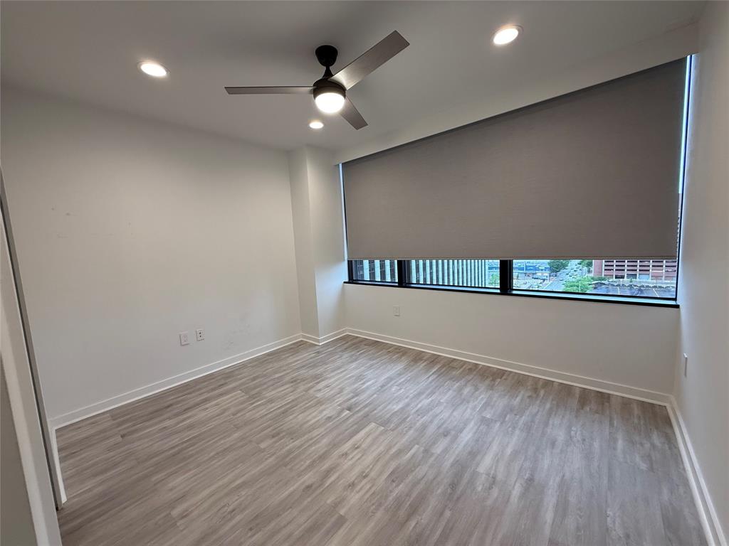 1200 Main Street, Unit 902 Dallas, TX 75202 - Photo 18 of 21 an empty room with wooden floor and windows