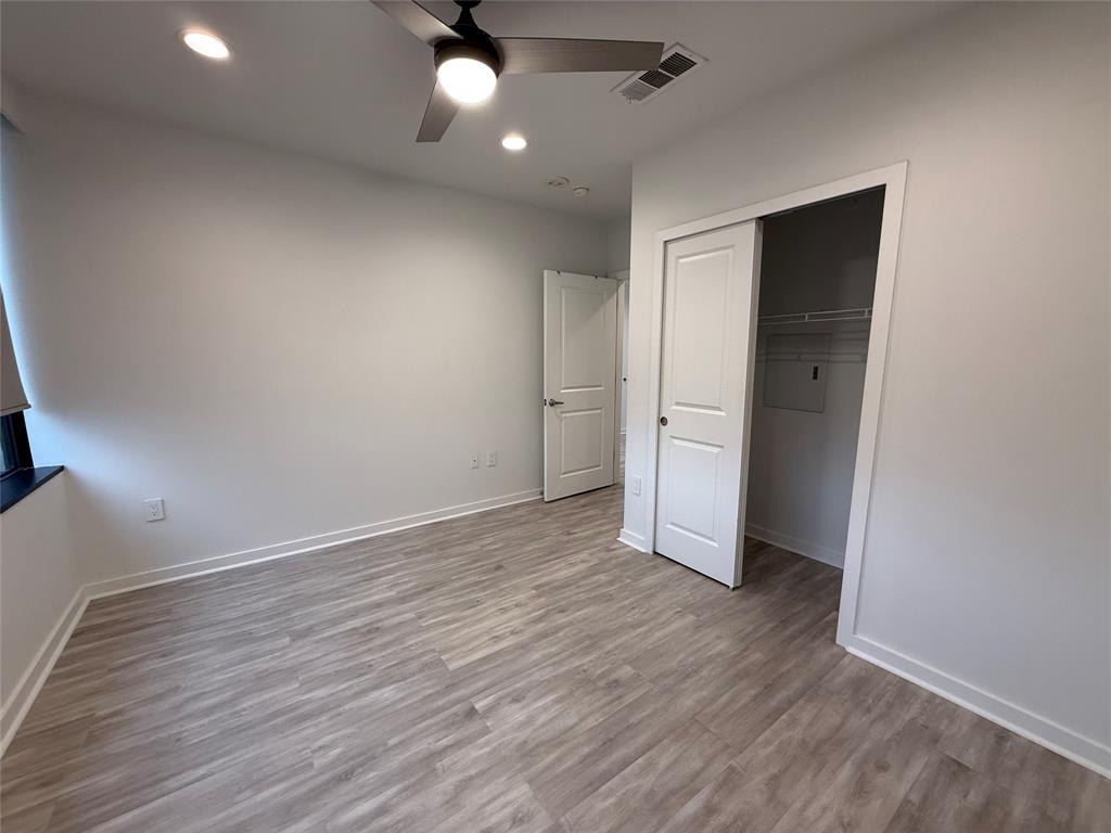 1200 Main Street, Unit 902 Dallas, TX 75202 - Photo 20 of 21 an empty room with wooden floor and windows