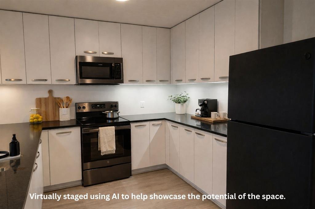 1200 Main Street, Unit 902 Dallas, TX 75202 - Photo 9 of 21 a kitchen with stainless steel appliances granite countertop a refrigerator a stove a microwave and sink