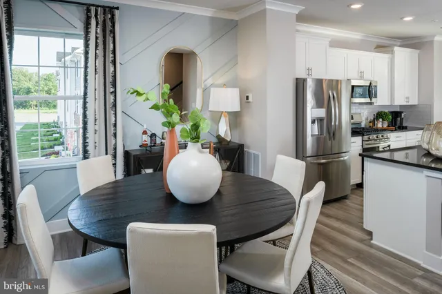 a kitchen with a table and chairs