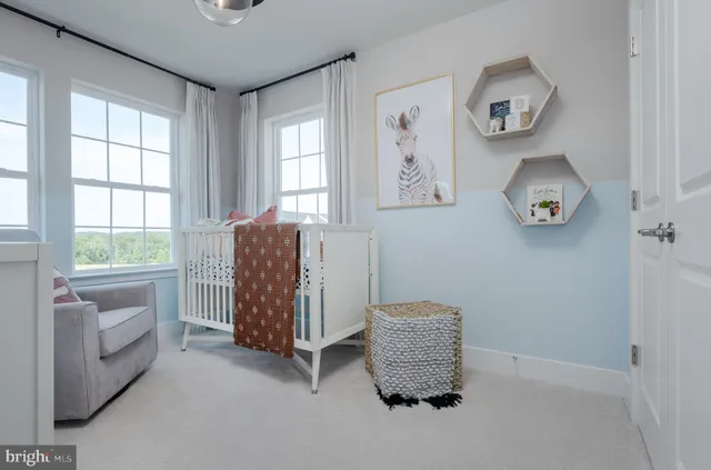 a room with a baby crib and a window