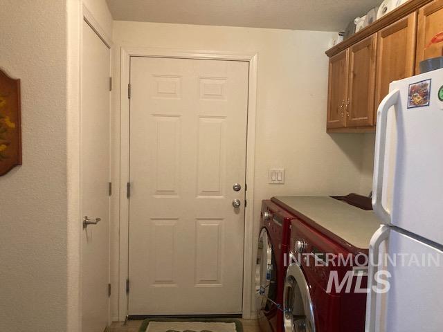 1095 County Road 70 Weiser, ID 83672 - Photo 21 of 44 Laundry area with overhead wood cabinetry and a functional countertop space