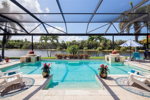 a view of yard with table and chairs under an umbrella