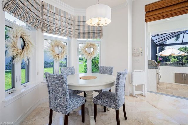a dining room with furniture a rug and a mirror