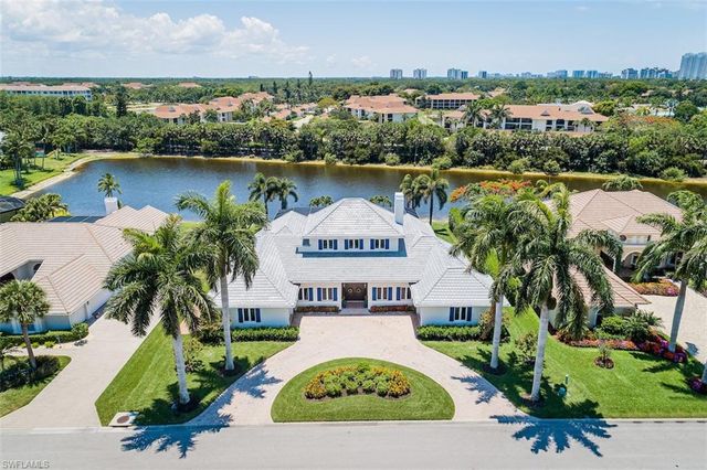 an aerial view of a house with garden space and lake view