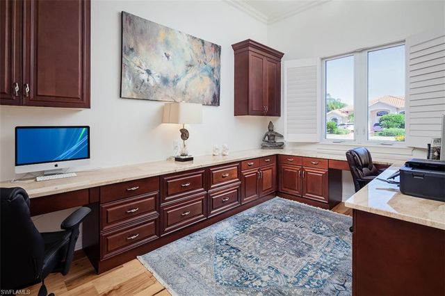 a kitchen with stainless steel appliances sink cabinets and window