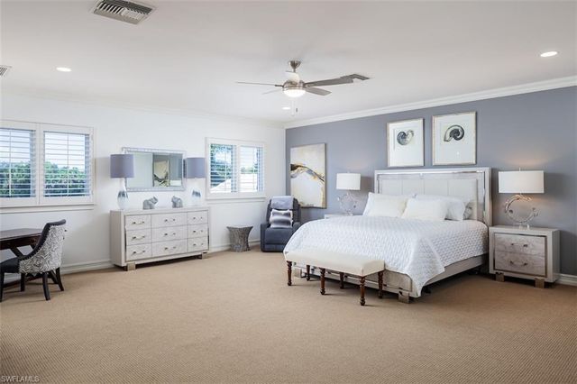 a spacious bedroom with a bed and a desk