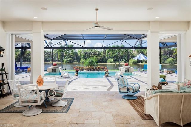 a very nice looking living room with a large window and furniture