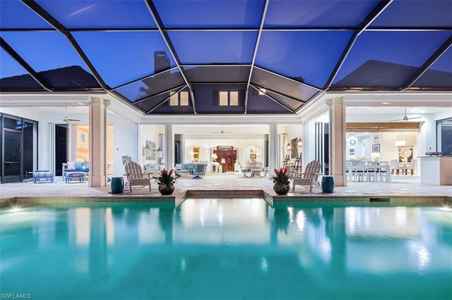 a living room with fireplace furniture and a large window