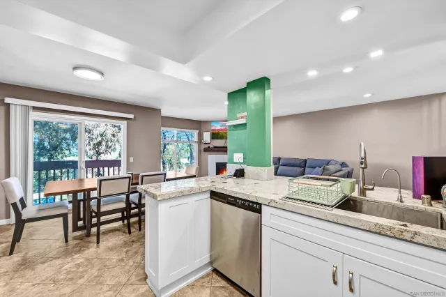 a kitchen with sink and chairs