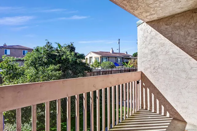 a view of a house with wooden fence