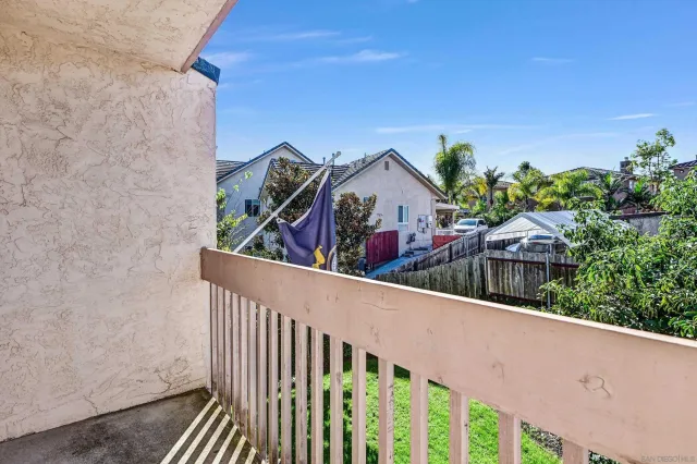 a view of a hallway with wooden floor and entryway
