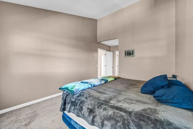 a bathroom with a granite countertop sink toilet a mirror and shower