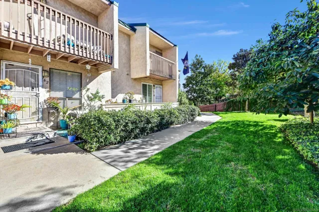 a front view of a building with a garden