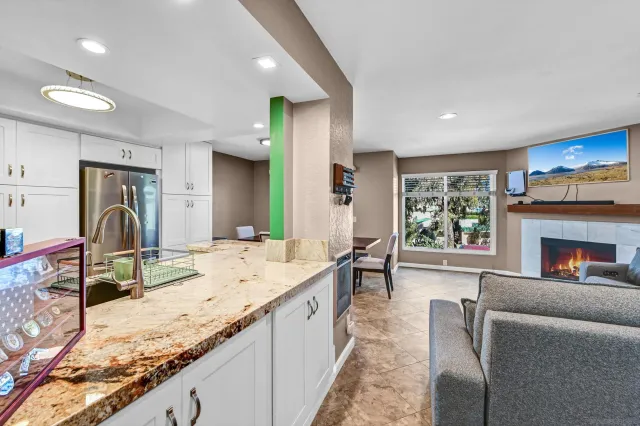 a spacious bathroom with a granite countertop sink and a large mirror