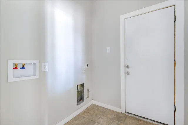 a view of a kitchen with wooden floor and electronic appliances