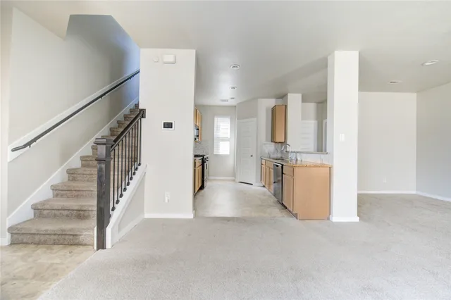 a kitchen with granite countertop a sink stove and cabinets