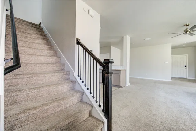 a view of a big room with closet and ceiling fan