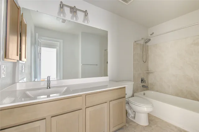 an empty room with a chandelier fan and closet area