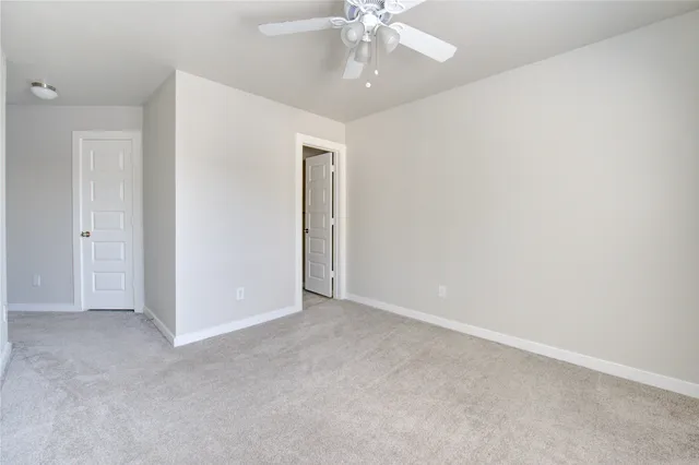 a view of a livingroom with a ceiling fan and window